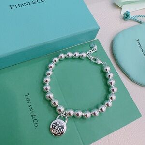 Tiffany & Co. Silver Bead Bracelet with Padlock Charm